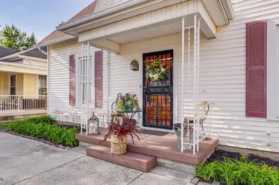 a home with a door with a wreath on it at Walkable Group Getaway with Bikes in West Liberty! in West Liberty