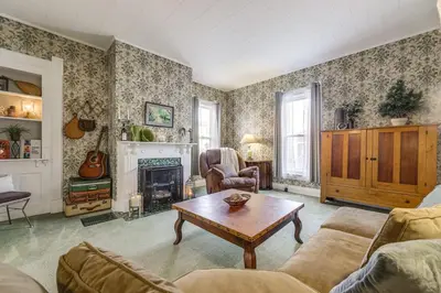 a living room with a couch and a table at Walkable Group Getaway with Bikes in West Liberty! in West Liberty