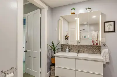 a bathroom with a sink and a mirror at Walkable Group Getaway with Bikes in West Liberty! in West Liberty