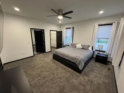 a bedroom with a bed and a ceiling fan at Country Cornerstone Retreat Upstairs Apartment with Hot Tub, Jetted Tub, Sauna, Massage Chair, BBQ in Hillsboro
