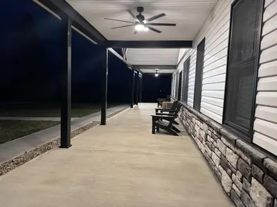 a porch with a ceiling fan and benches on a house at Country Cornerstone Retreat Upstairs Apartment with Hot Tub, Jetted Tub, Sauna, Massage Chair, BBQ in Hillsboro