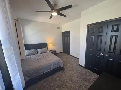 a bedroom with a bed and a ceiling fan at Country Cornerstone Retreat Upstairs Apartment with Hot Tub, Jetted Tub, Sauna, Massage Chair, BBQ in Hillsboro