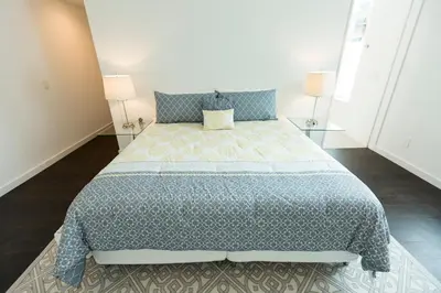a bedroom with a large bed and two lamps at Unique contemporary 1600ft2 2BR 3BA apt OTR in Cincinnati