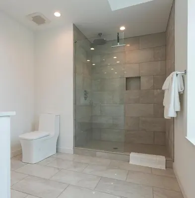 a bathroom with a shower and a toilet at Unique contemporary 1600ft2 2BR 3BA apt OTR in Cincinnati