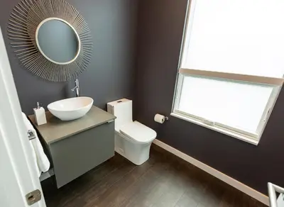 a bathroom with a sink and a toilet and a mirror at Unique contemporary 1600ft2 2BR 3BA apt OTR in Cincinnati