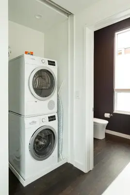 a washing machine and a washer in a bathroom at Unique contemporary 1600ft2 2BR 3BA apt OTR in Cincinnati