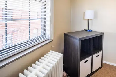 a room with a tv and a radiator and a window at Pet-Friendly Serenity Spot on Dorthy Lane in Dayton