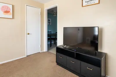 a living room with a large flat screen tv at Pet-Friendly Serenity Spot on Dorthy Lane in Dayton