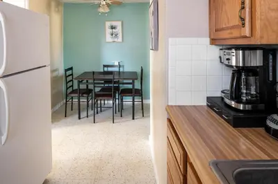 a kitchen with a table and a white refrigerator at Pet-Friendly Serenity Spot on Dorthy Lane in Dayton