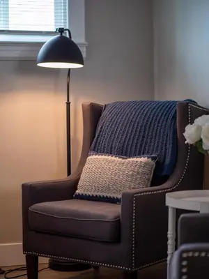 a lamp sitting next to a chair with a pillow at 3584 Blanche Ave in Cleveland Heights