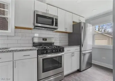 a kitchen with stainless steel appliances and a microwave at 3584 Blanche Ave in Cleveland Heights