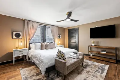 a bedroom with a large bed and a flat screen tv at The Luxe/Pickleball/Basketball/ Hot Tub/Horse Park in Georgetown