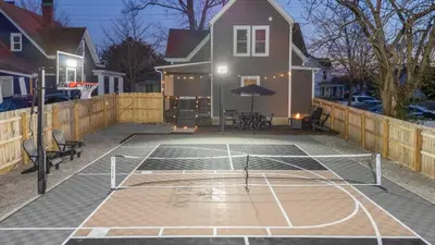 a basketball court with a net in front of a house at The Luxe/Pickleball/Basketball/ Hot Tub/Horse Park in Georgetown