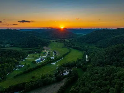 an aerial view of a valley with a sunset at Furnished Glamping Tent/River Access/2 Queen Beds in Stanton