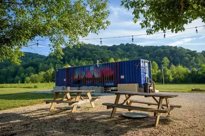 two picnic tables in a park with a container at Furnished Glamping Tent/River Access/2 Queen Beds in Stanton