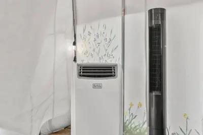 a refrigerator freezer sitting next to a wall at Furnished Glamping Tent/Red River Access/King Bed in Stanton