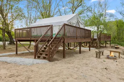 a yurt on a playground with stairs and a fire at Furnished Glamping Tent/Red River Access/King Bed in Stanton
