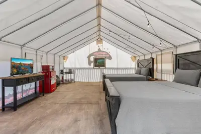a tent with two beds and a tv in it at Furnished Glamping Tent/River Access/2 Queen Beds in Stanton