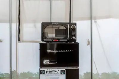 a microwave sitting on top of a box at Furnished Glamping Tent/Red River Access/King Bed in Stanton