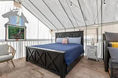 a bedroom with a bed in a tent at Furnished Glamping Tent/Red River Access/King Bed in Stanton