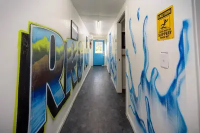 a hallway with blue paint on the walls at Glamping Tent/Red River Access/2 Queen Beds in Stanton