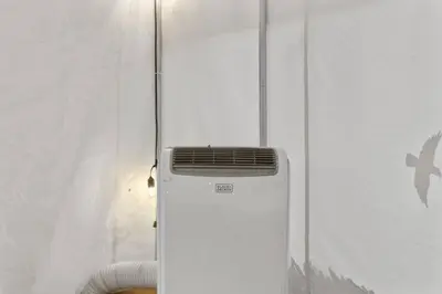a air conditioner sitting on the side of a wall at Glamping Tent/Red River Access/2 Queen Beds in Stanton