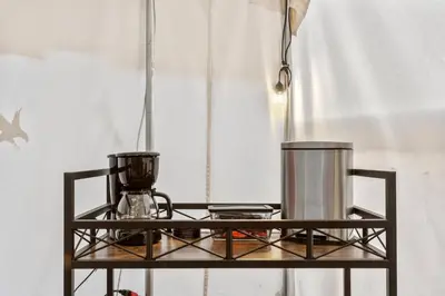 a metal shelf with a blender on top of it at Glamping Tent/Red River Access/2 Queen Beds in Stanton