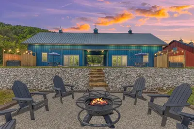 a fire pit in front of a blue building at New Barndo/King Beds/Hot Tub/Ample Level Parking in Stanton