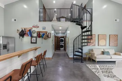 a spiral staircase in a living room with a couch at New Barndo/King Beds/Hot Tub/Ample Level Parking in Stanton