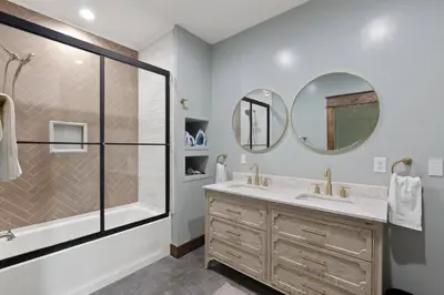a bathroom with a shower and a sink and mirrors at New Barndo/King Beds/Hot Tub/Ample Level Parking in Stanton