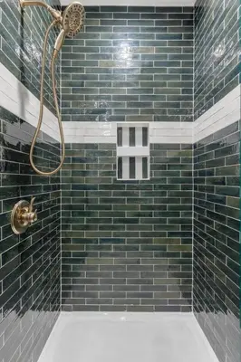 a bathroom with a shower with blue tiles at New Barndo/King Beds/Hot Tub/Ample Level Parking in Stanton