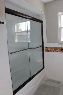 a glass shower in a bathroom with a window at Cozy Meets Luxury in Tylersville