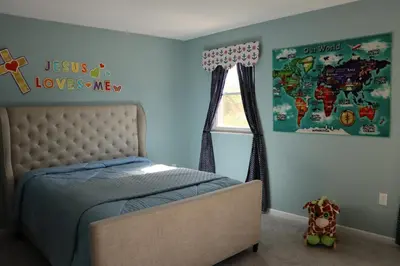 a bedroom with a bed and a map of the world at Cozy Meets Luxury in Tylersville