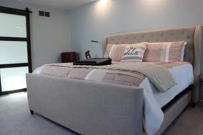 a bedroom with a bed with a laptop on it at Cozy Meets Luxury in Tylersville