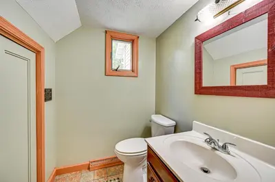 a bathroom with a toilet and a sink and a mirror at Rural and Private Dover Retreat Close to Wineries! in Dover