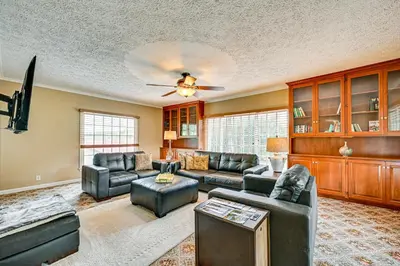 a living room with leather furniture and a ceiling fan at Rural and Private Dover Retreat Close to Wineries! in Dover