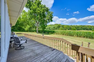 a porch with a chair on a wooden deck at Rural and Private Dover Retreat Close to Wineries! in Dover