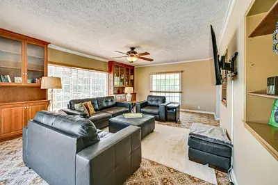 a living room with leather furniture and a ceiling fan at Rural and Private Dover Retreat Close to Wineries! in Dover