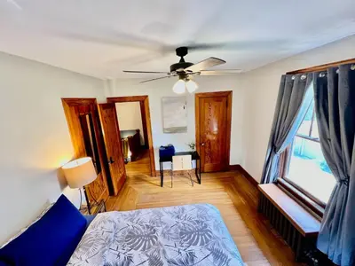 a bedroom with a bed and a ceiling fan at Southern Charm Private Queen Bedroom Suite 2 in Cincinnati
