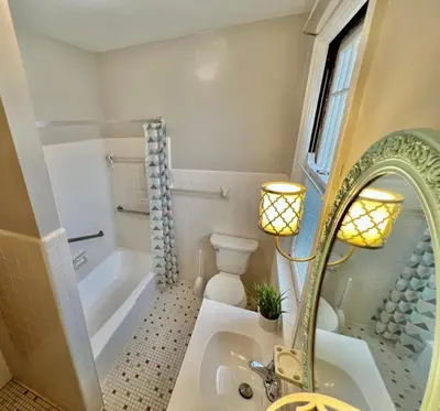 a bathroom with a sink and a tub and a mirror at Southern Charm Private Queen Bedroom Suite 2 in Cincinnati