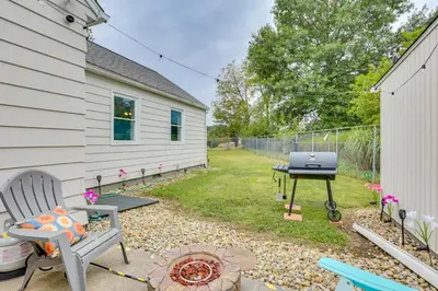 a backyard with a barbecue grill and a chair at 4 Mi to Main Street! Family Getaway in Zanesville in Zanesville