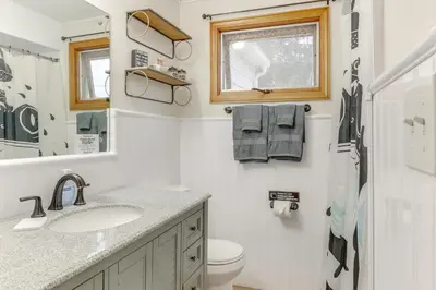a bathroom with a sink and a toilet and a window at 4 Mi to Main Street! Family Getaway in Zanesville in Zanesville
