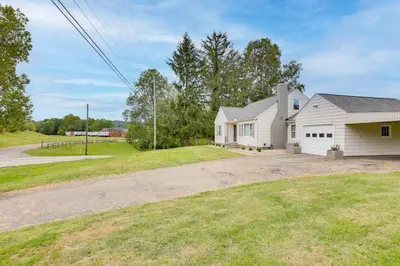 a white house with a driveway and a yard at 4 Mi to Main Street! Family Getaway in Zanesville in Zanesville