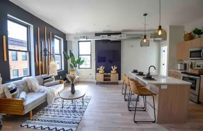 a kitchen and living room with a couch and a table at OTR by TQL+King Bed+Light Rail+Dedicated Parking in Cincinnati
