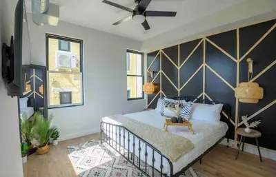 a bedroom with a bed with a blue wall at OTR by TQL+King Bed+Light Rail+Dedicated Parking in Cincinnati