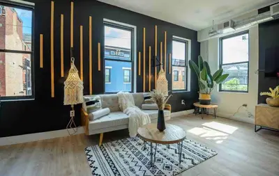 a living room with a couch and a table at OTR by TQL+King Bed+Light Rail+Dedicated Parking in Cincinnati