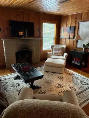 a living room with a couch and a fireplace at House Upon a Hill in Newton Falls