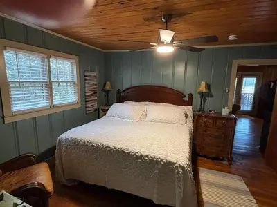 a bedroom with a bed and a ceiling fan at House Upon a Hill in Newton Falls