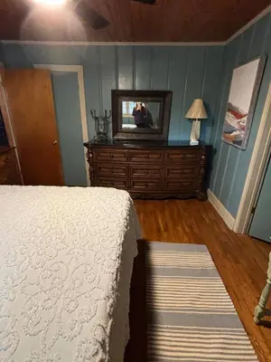 a bedroom with a bed and a television on a dresser at House Upon a Hill in Newton Falls