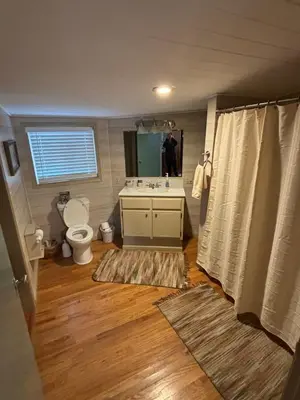 a bathroom with a toilet and a sink at House Upon a Hill in Newton Falls